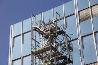 Steel scaffolding on the large glass façade of an office building