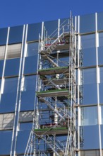 Steel scaffolding on the large glass façade of an office building