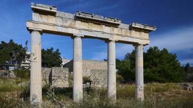 Ancient column ruins under a blue sky in a historic landscape, Archaeological site, Xysto Columned