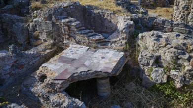 Detail of an ancient ruined site with stone structures and small staircase, Archaeological site,
