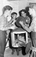 Young men craftsmen, 1950s, Group of young men working with technical equipment in a workshop,