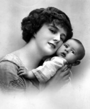 Mother with baby, close-up of a woman lovingly embracing her baby, historical photo