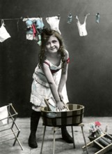 Girl at the washboard, 1920, Girl washing clothes in a wooden bucket, in the background more