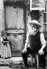 Granddaughter paints her smoking grandpa, 1910, An elderly man with a beard sits in front of a door