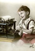 Boy at typewriter, 1920, Boy with glasses playing happily at an old typewriter, he seems to be