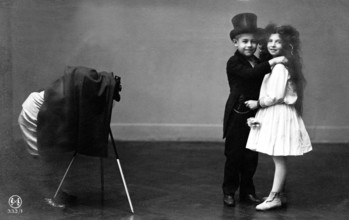 Children wedding couple photographer, 1920, Two children in formal wear smiling and posing in front