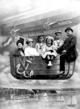 Family in balloon dummy, 1910s, A family sits in the gondola of an airship with the name Hansa over