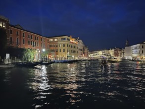 Gondolas on the Grand Canal, Rialto Bridge in the background, night shot, lagoon city of Venice,