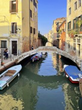 Boats and gondolas on a canal in Venice, lagoon city of Venice, Veneto, Italy