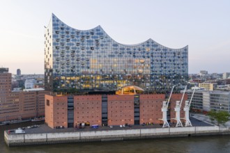 The Elbphilharmonie concert hall in Hamburg is reflected in the glass design above the historic