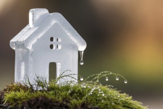 Ice cube-shaped house symbolizing air conditioning, eco living, and climate control in a warming