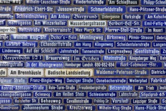 Dense collection of blue street signs with various street names, Amorbach, Odenwald, Bavaria,