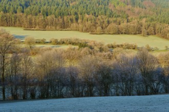 Winter landscape with fields and wooded hills in the morning light, Kirchzell, Amorbach, Odenwald,