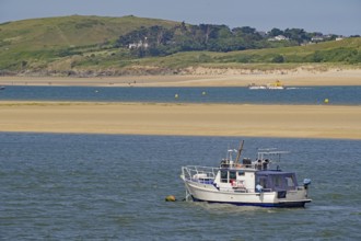 Motorboat on calm water near a green coast with hills in the background, Camel Trail, Padstow,