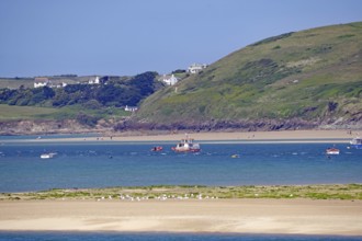 Coastal landscape with boats on blue water and green wooded hills, Padstow, Cornwall, Cornwall,