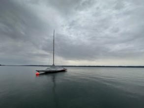 Sailing boat, dark clouds over Lake Starnberg, Bavaria, Germany