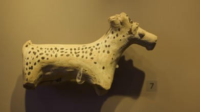 Ceramic figure of a spotted animal, exhibited in a museum-like room, Archaeological Museum, Kos