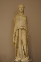Marble sculpture of an ancient woman in elegant garb, presented in the museum, Archaeological