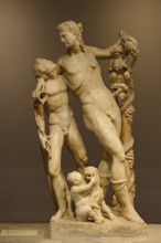 Ancient marble sculpture depicting several figures, including children and adults, satyr and Pan,