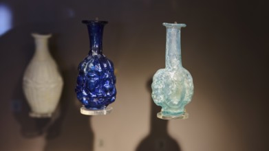 Antique decorative glass bottles in blue and turquoise with relief decoration, Archaeological