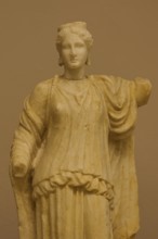 Marble statue of an ancient woman in classical dress, on display in a museum, Archaeological