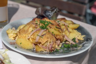 Omlett with fried potatoes served in a beer garden, Bavaria, Germany