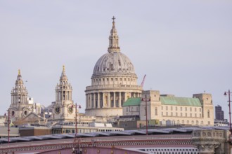 Large cathedral with a powerful dome surrounded by further towers in an urban area, London, United