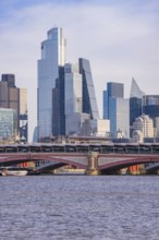 Modern skyscrapers on the river and a large bridge in the foreground, London, United Kingdom, World