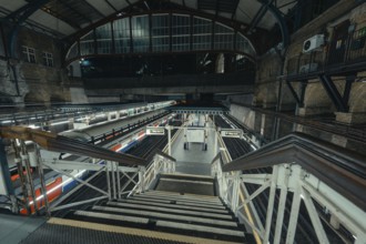 View of empty platform with trains and industrial architecture of a train station, London, United