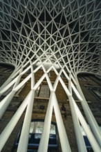 Futuristic geometric ceiling pattern with white pillars in modern architecture, King's Cross