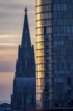 Cologne Cathedral, church towers, round façade of the Cologne Triangle Hochaus in Cologne-Deutz,