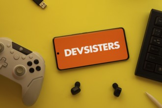 Dhaka, Bangladesh- 23 March 2025: Devsisters logo displayed on a smartphone surrounded by gaming
