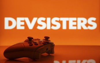 Dhaka, Bangladesh- 20 Mar 2025: A close-up of a white gamepad with the Devsisters seen on screen in