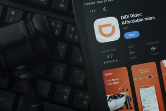 Dhaka, Bangladesh- 28 Oct 2025: An iPad displaying the DiDi Rider app against a judge's gavel and