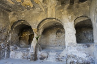 Ancient cave with stone arches and interior details, historic setting, Tamaris Darbasi, Tamaras