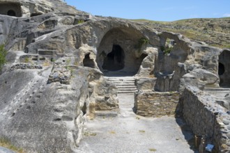 Ancient rock construction with several entrances and a natural setting, Uplistsikhe cave town,