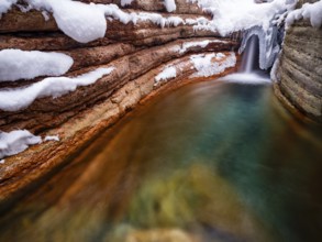 Taugl or Tauglbach flows through the snow-covered and icy red gorge, also Marmorklamm, Bad Vigaun,