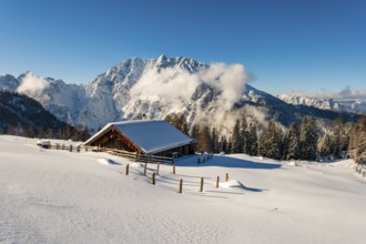 Deep snow-covered Priesbergalm, Watzmann with clouds behind, Berchtesgaden Alps, Berchtesgaden
