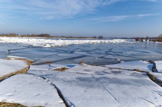 Ice on the banks of the Elbe and remnants of snow in the foothills of the Elbe on a clear winter
