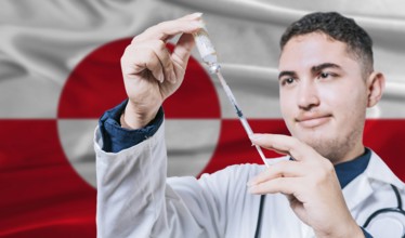 Doctor holding syringe on Greenland flag background. Medical professional holding syringe with