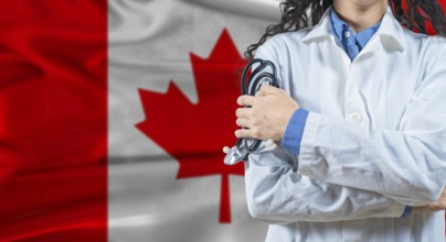 Healthcare professional with Canada flag background. Professional doctor holding stethoscope on