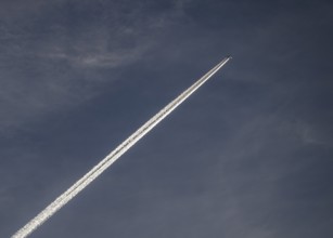 Contrails and passenger jets high in the sky