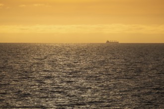 Silhouette, cargo ship, evening light, Baltic Sea