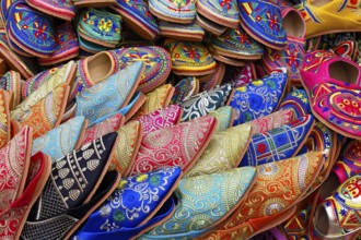 Sales stand with traditional colorful slippers at a market in Marrakech, historic old town, Medina,