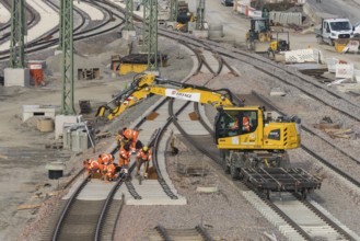 Workers and excavators renovating railroad tracks on a municipal construction site, Untertürkheim