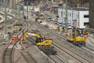 Several workers and excavators on a railway construction site in an urban area, Untertürkheim