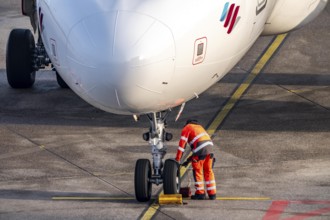 Ground crew positions brake blocks on the chassis, after stopping at the parking position, at the