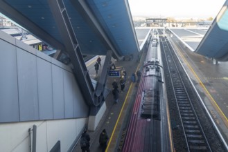 Modern architecture looking down on Class 220 Voyager diesel-electric multiple unit train, Reading