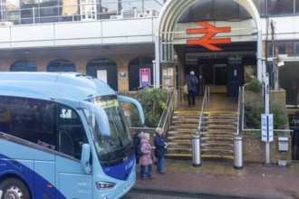 RailAir bus coach parked outside railway station entrance, Reading, Berkshire, England, UK
