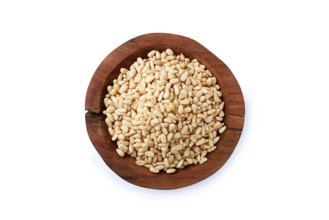 Peeled pine nuts, in a wooden bowl, on a white background, isolate, close-up, no people